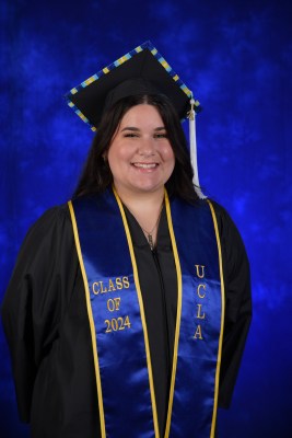 Brianna's formal UCLA graduation portrait wearing UCLA regalia and cap and gown. 