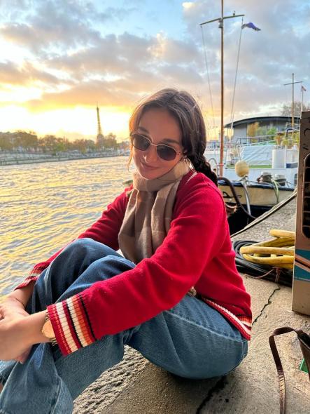 Maya in Paris, France, with the Eiffel Tower in the background.