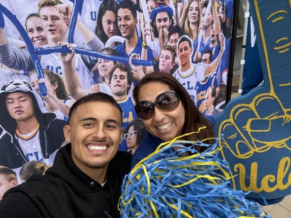 Samuel showing school spirit holding a UCLA foam finger. 