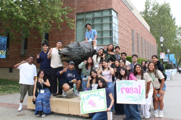 Group photo of the Kindred and Purpose Weekend for Admits attendees with Camille in front of the Bruin Bear statue. 