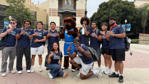 Divine posing with fellow New Student Advisors with the Joe Bruin mascot in Bruin Plaza at UCLA.
