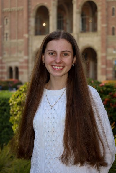 Professional photo of Camila in front of Royce Hall at UCLA. 
