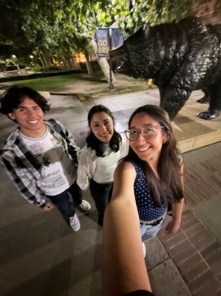 Selfie with Fabrizio and his friends next to the Bruin bear statue at night. 