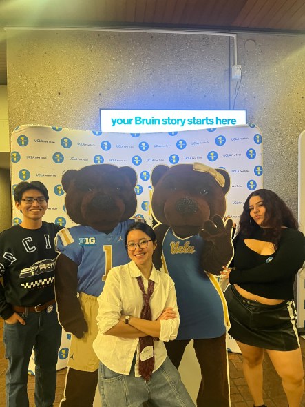 Namuun and fellow first-generation students with cardboard cut-outs of mascots Joe and Josie Bruin at a UCLA First To Go event. 