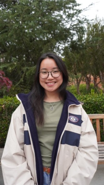Namuun smiling at the camera and standing on campus. 